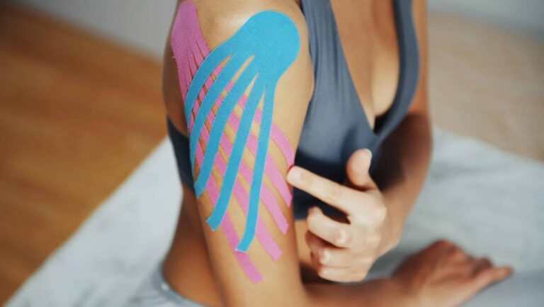 sportive woman sits indoors with kinesio tape on h 2023 11 27 05 15 50 utc scaled e1709142383675